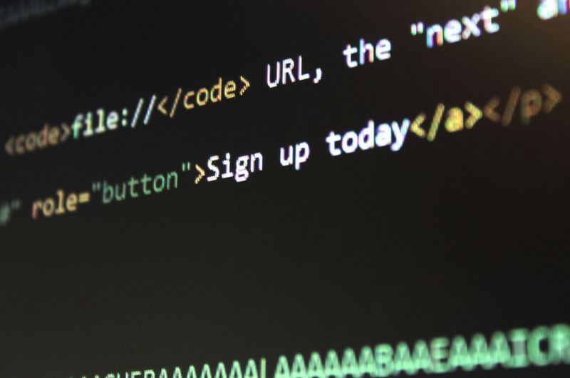 HTML and CSS code on a screen showing the link markup that forms the foundation of anchor text