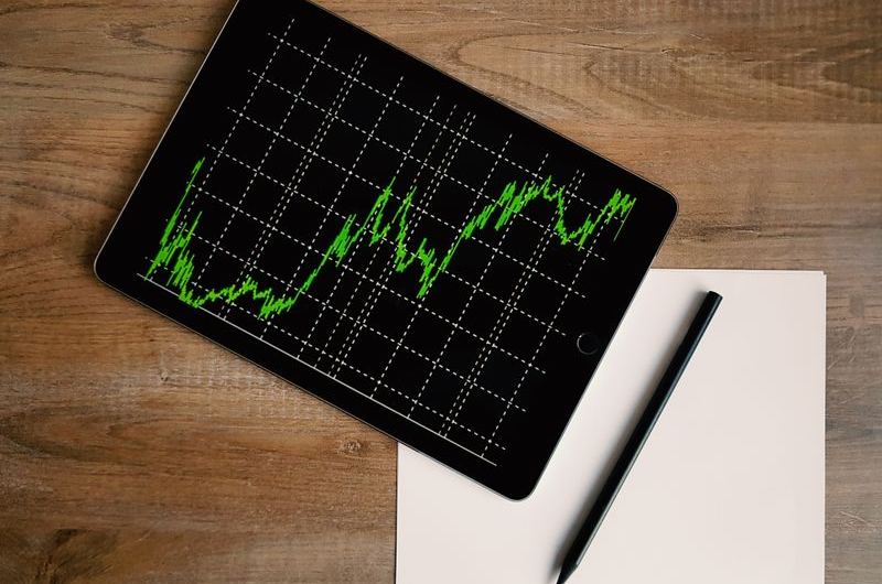 A laptop screen showing performance data graphs similar to Google Search Console reports