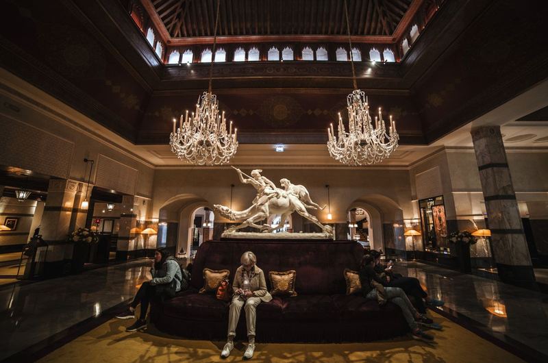 An elegant hotel lobby with chandeliers and seating, the type of property that hotel SEO helps travelers discover
