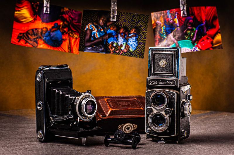 Cameras displayed alongside photographs, representing the visual content that image SEO helps search engines understand
