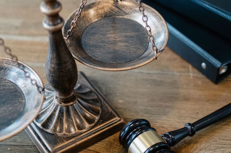 Scales of justice and a gavel on a wooden surface, symbolizing the legal profession and law firm SEO