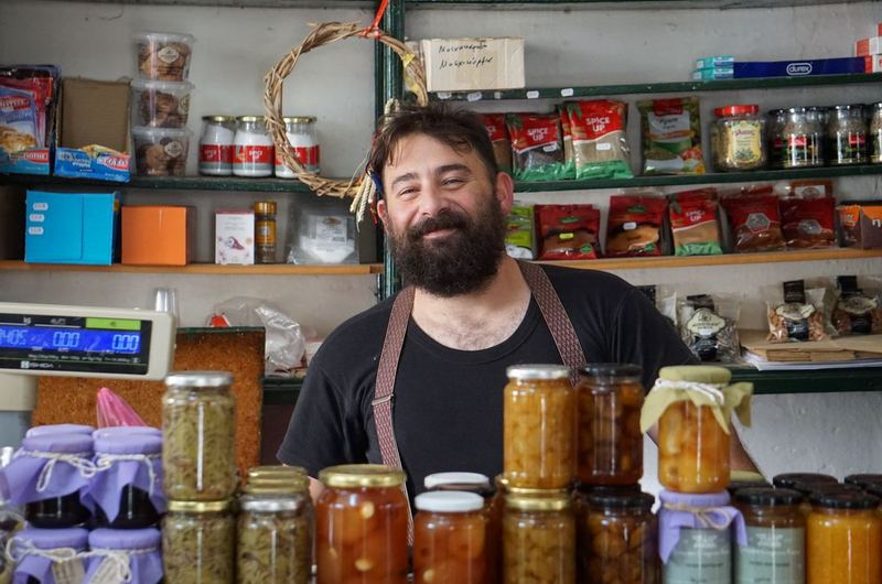 A shopkeeper at their store counter, the type of local business owner who benefits from local SEO