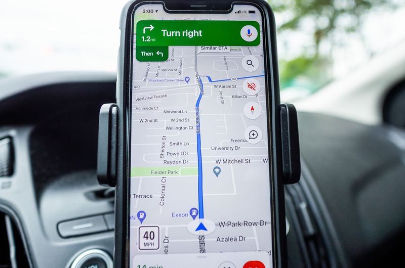 A smartphone in a car showing GPS navigation, the real-world use case Google Maps optimization supports