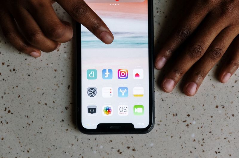 A person browsing on their smartphone, the primary device that mobile SEO ensures works well for search