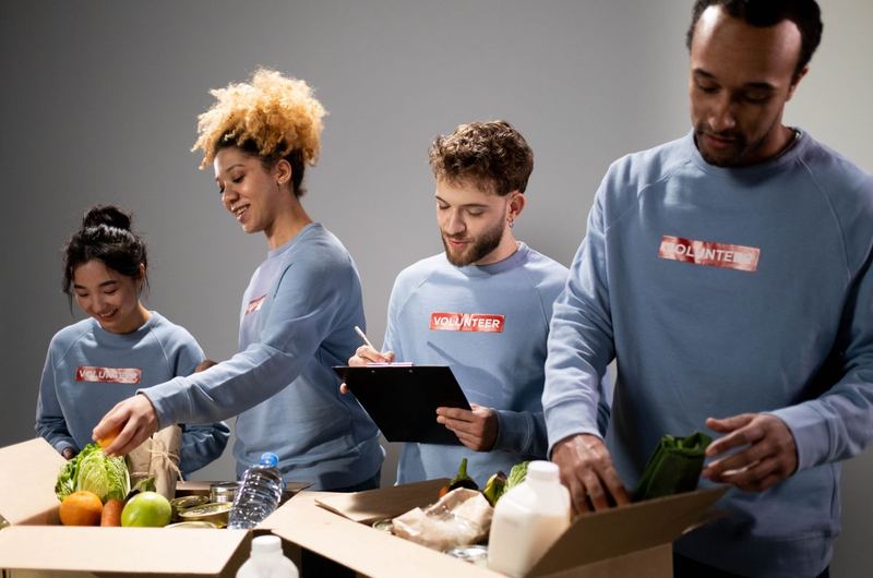Volunteers working together to pack donations, representing the nonprofits that NGO SEO helps reach supporters