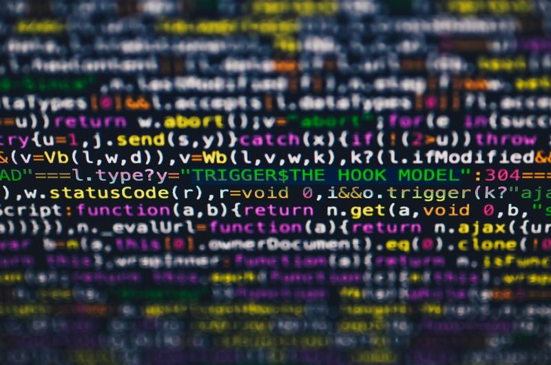Colorful programming code on a screen, representing the automated template-based approach of programmatic SEO