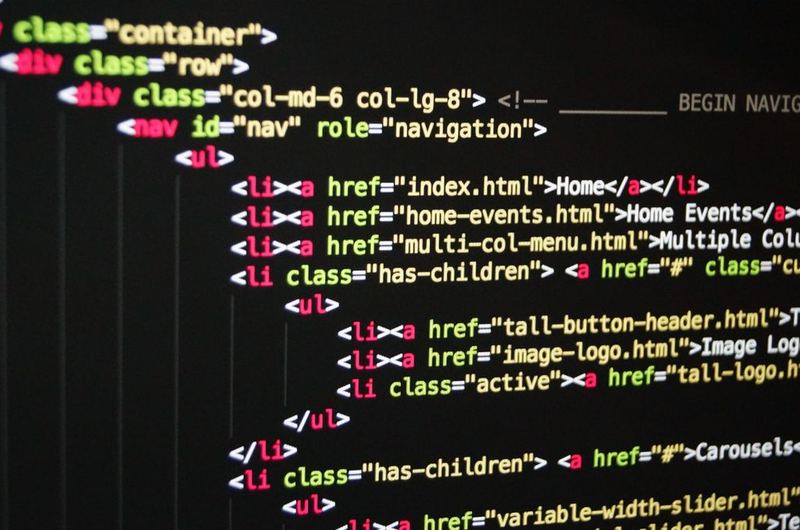 Close-up of HTML code on a screen, representing the redirect status codes that guide browsers and search engines