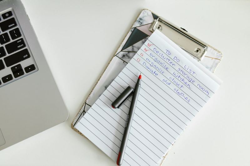 A checklist on a clipboard next to a laptop, representing the systematic approach to launching an SEO-ready site