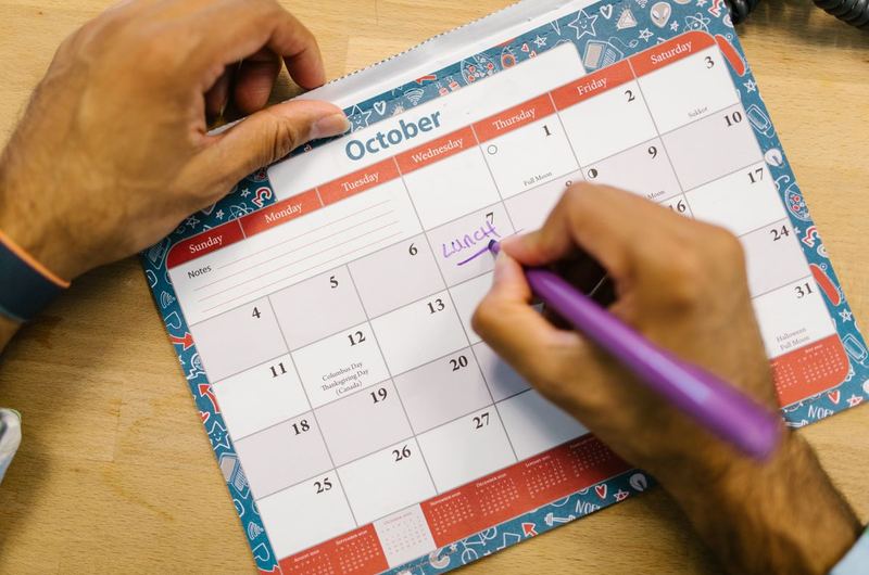A calendar with a pen marking dates, representing the timeline and patience needed for SEO results