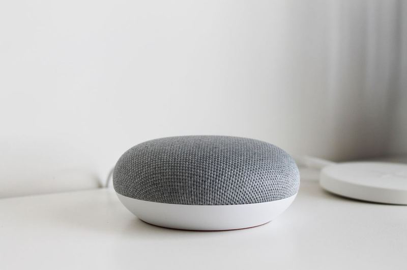 A smart speaker on a clean surface, the device that voice search optimization helps businesses reach through