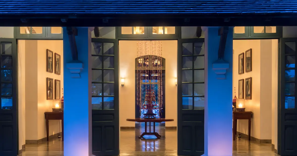 Entrance to a hotel lobby at dusk in Laos, illustrating a hotel booking journey