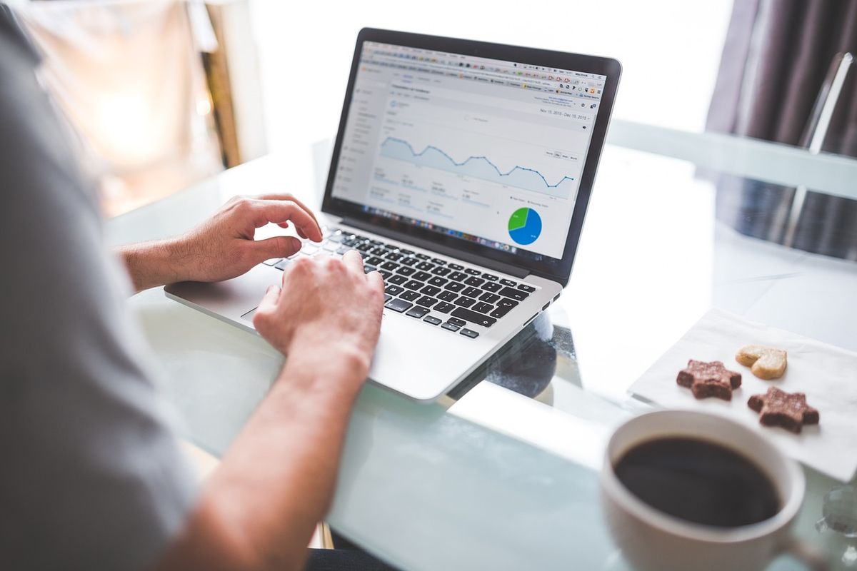 Laptop displaying analytics dashboard with ranking charts, representing Google ranking factor analysis