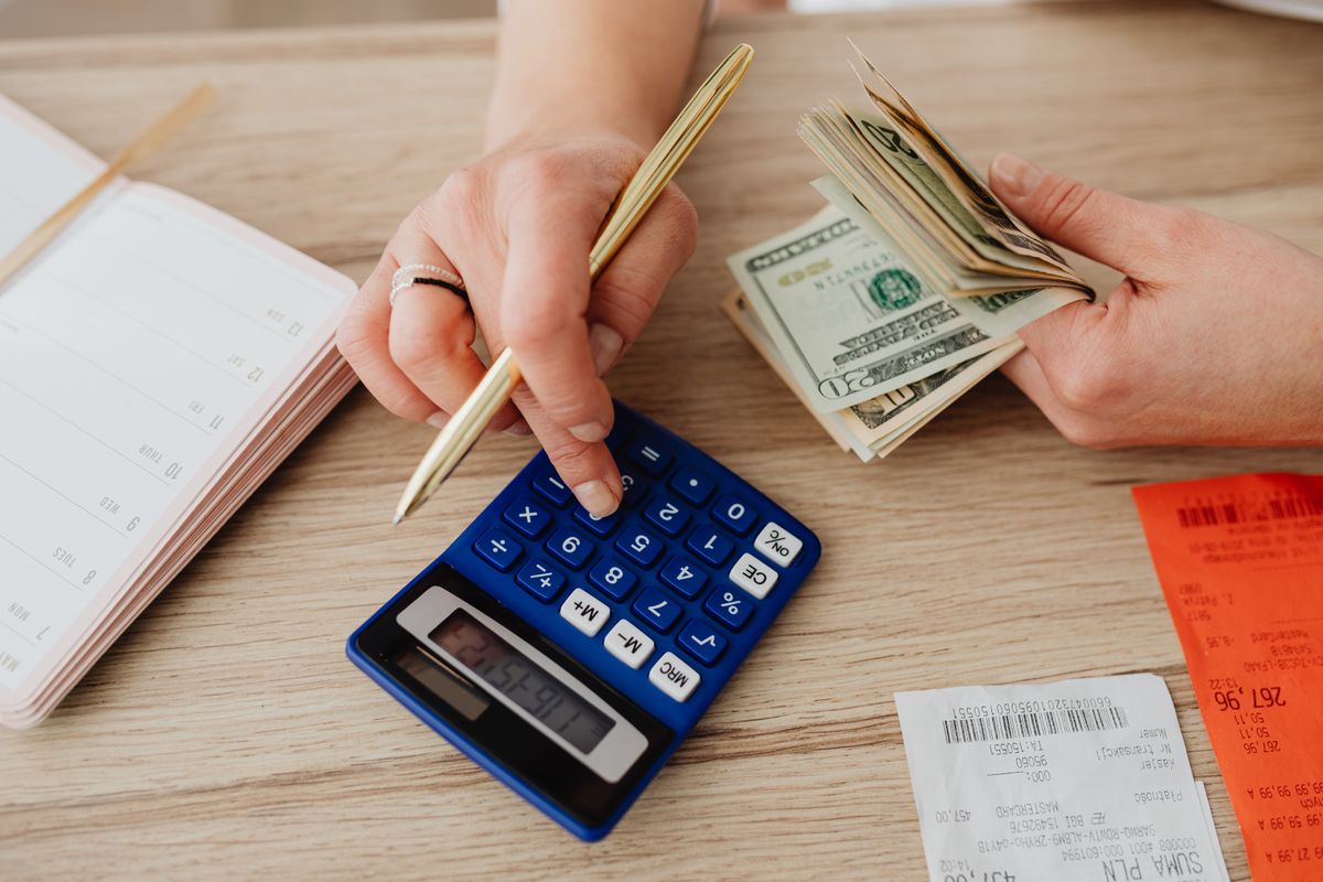 Coins stacked beside a calculator, a reminder that SEO is a patient, compounding investment