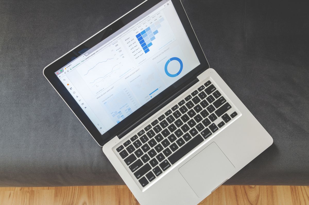 A laptop showing marketing performance charts, the kind used to plan and track a Google Ads budget