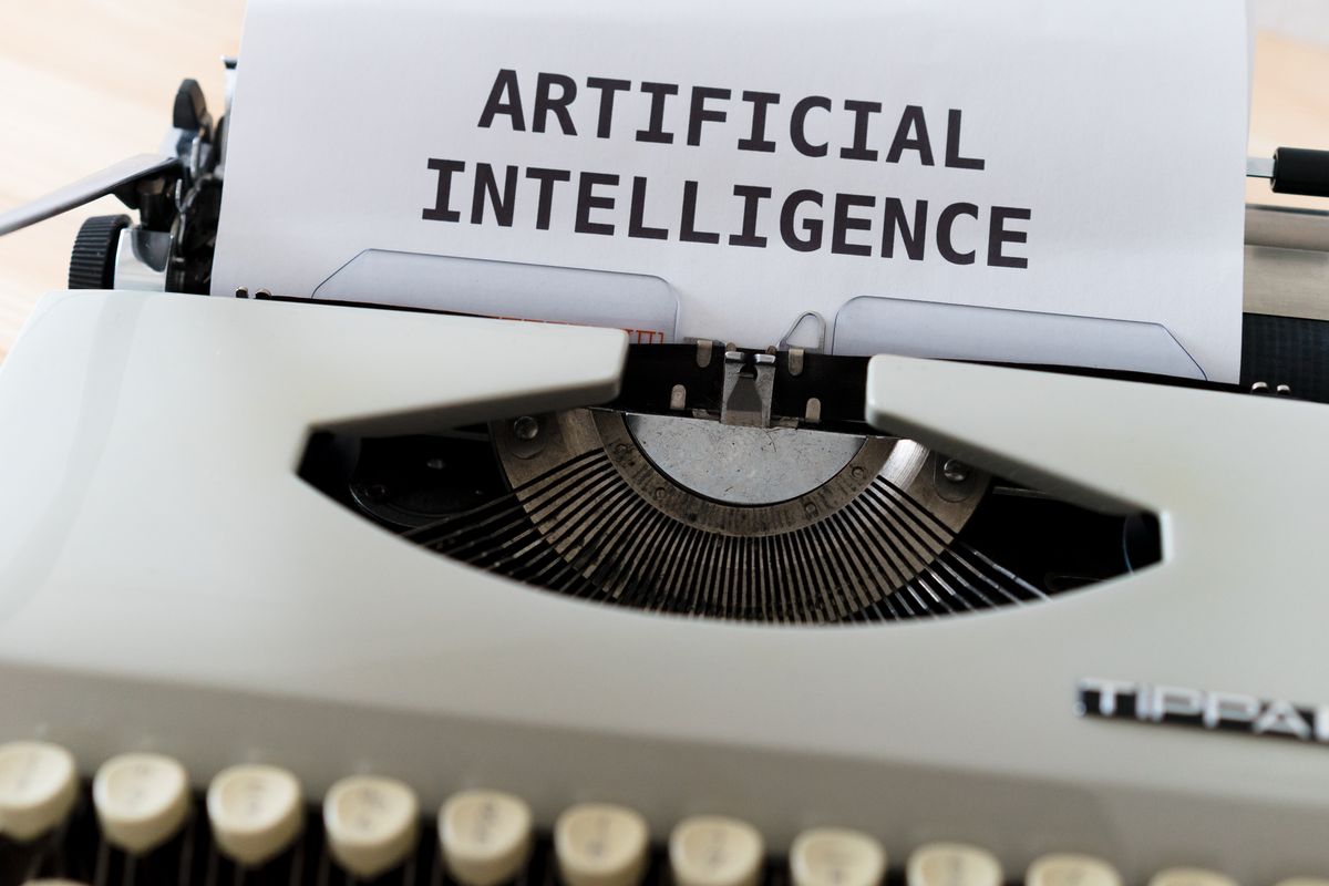 A typewriter with the words Artificial Intelligence typed on a sheet of paper