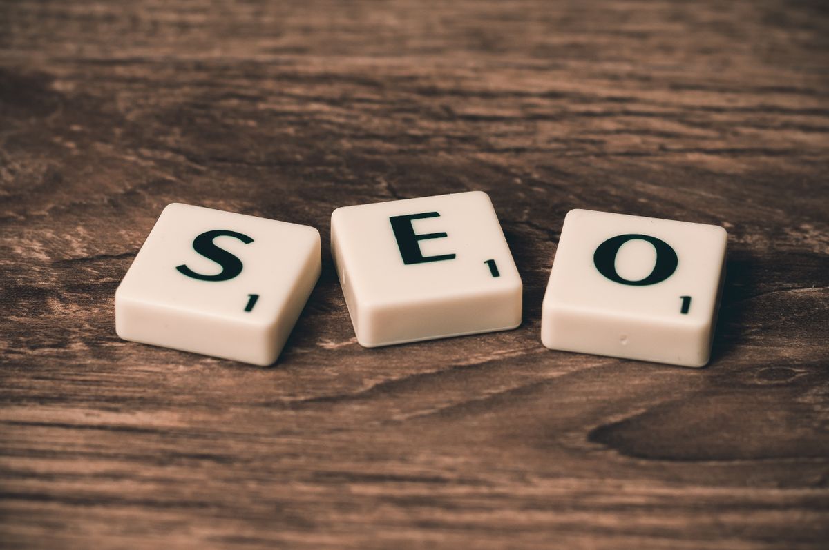 Scrabble letter tiles spelling out SEO on a wooden surface