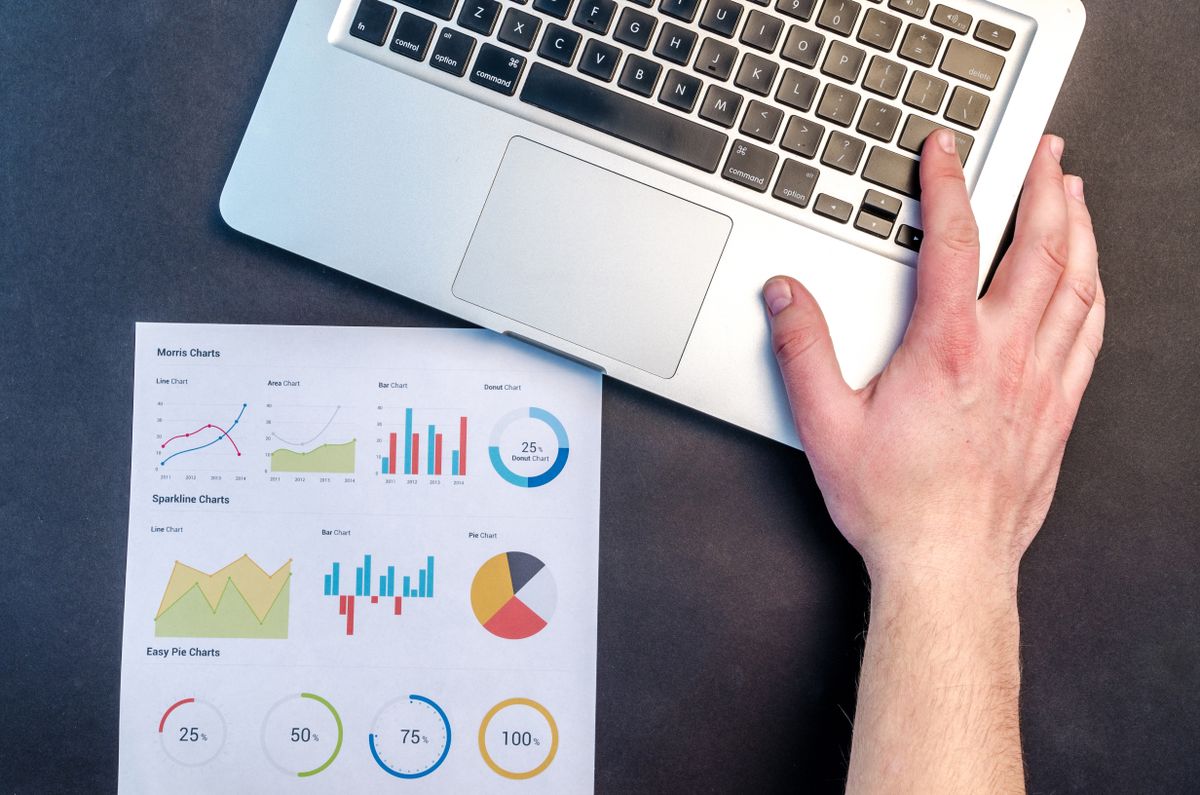 A laptop showing a rising traffic graph, the payoff of ranking higher on Google
