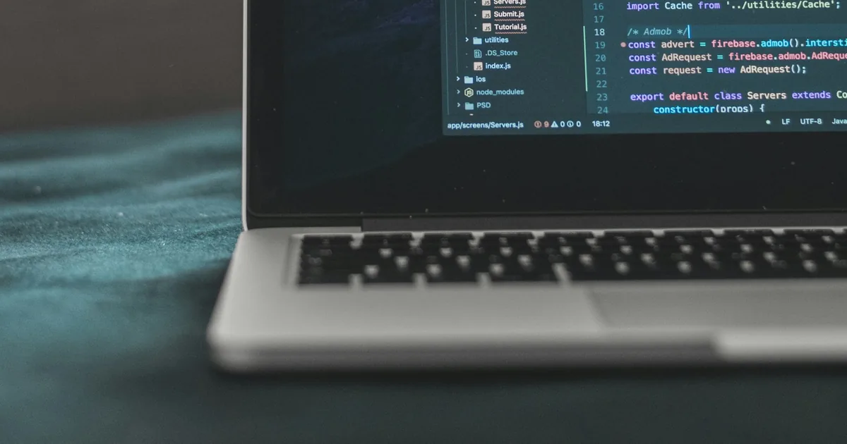 Laptop showing programming code on a desk, illustrating a web performance investigation.