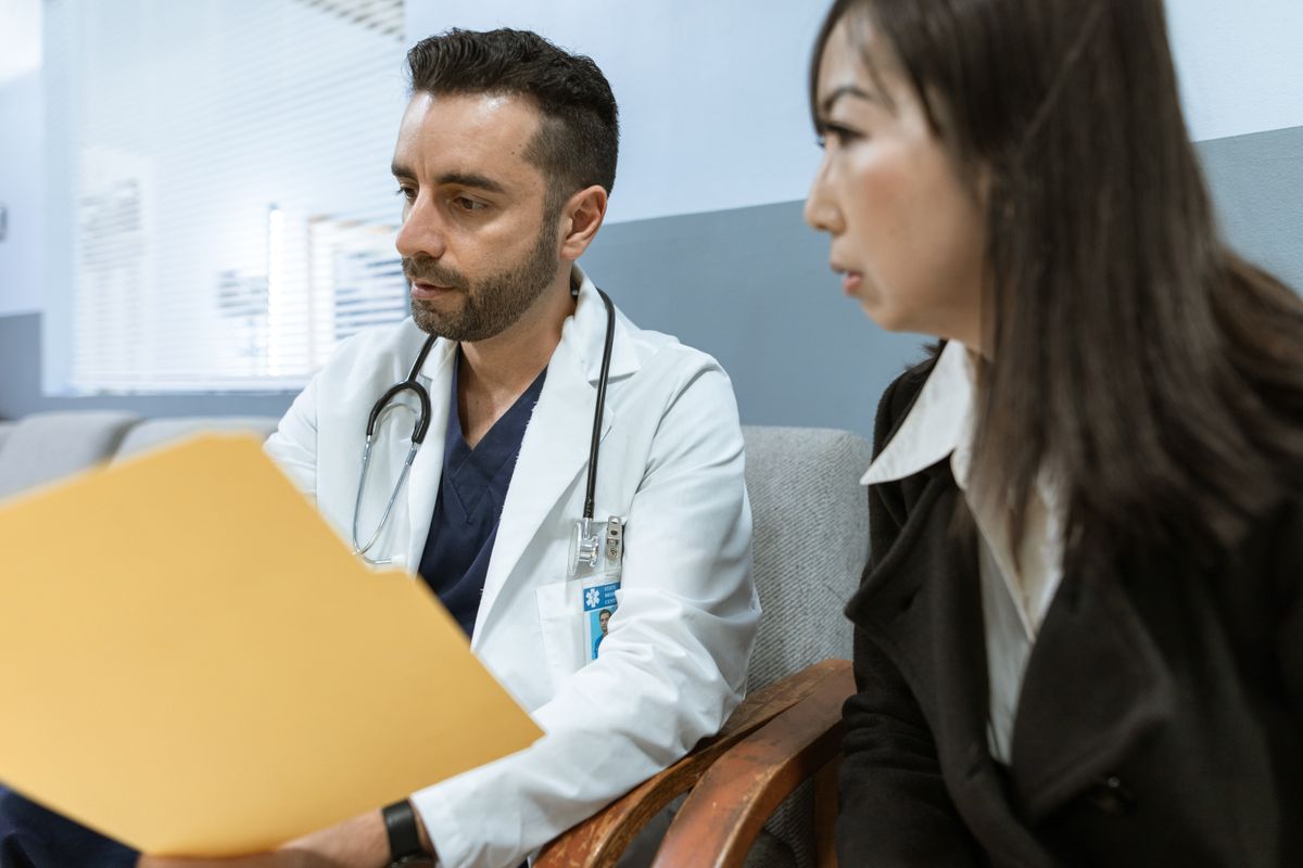 A doctor in a clinic consulting with a patient, the trusted care patients look for when they search on Google