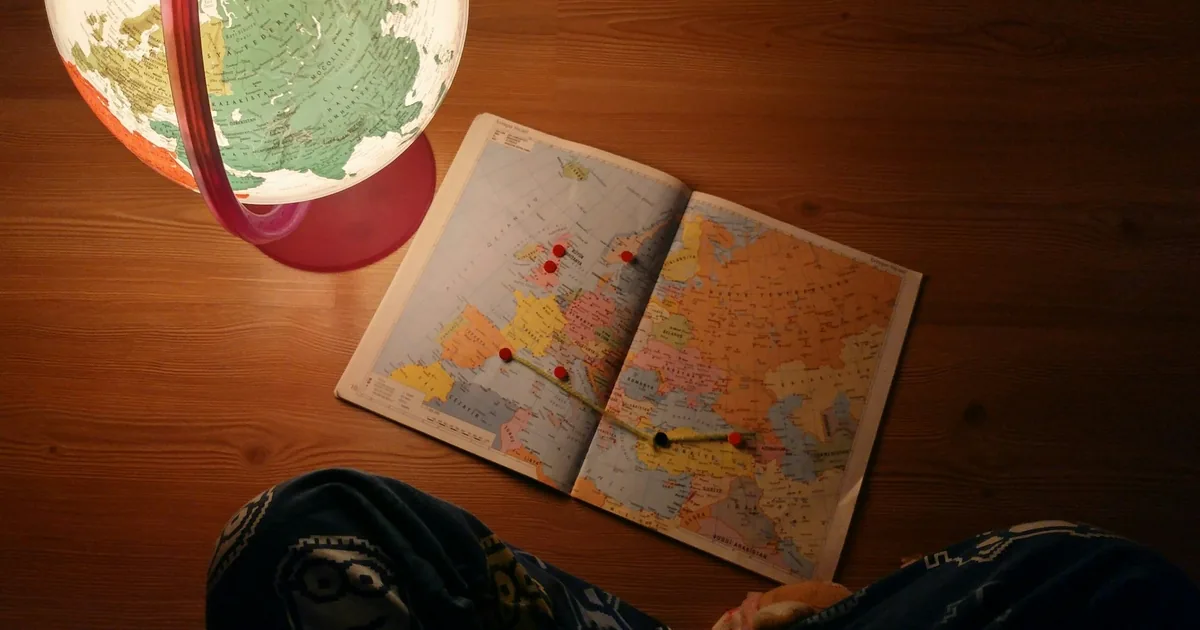 World map and desk globe, illustrating regional storefront planning for Shopify Markets.