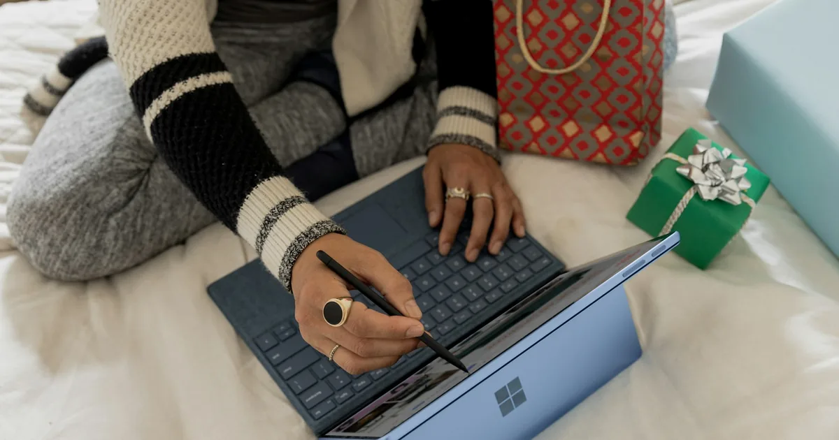 Person browsing an online shop on a laptop, illustrating product price consistency checks.