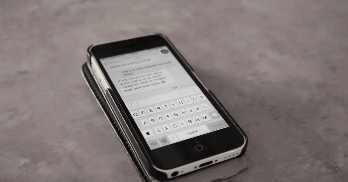 Person writing a message on a smartphone