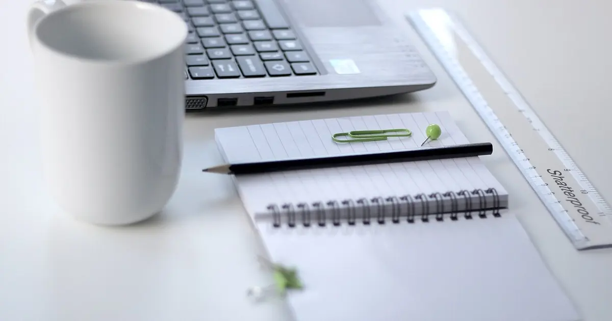 Laptop, ruler and planning notes on a desk, illustrating website redesign checks