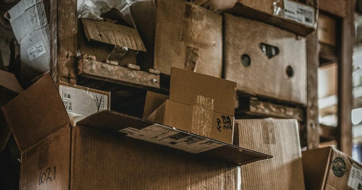 Cardboard shipping boxes stacked in a storage area, illustrating an ecommerce catalog.