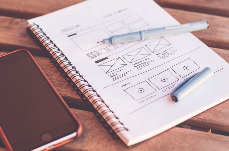 A mobile phone and laptop showing a website layout, representing landing page design