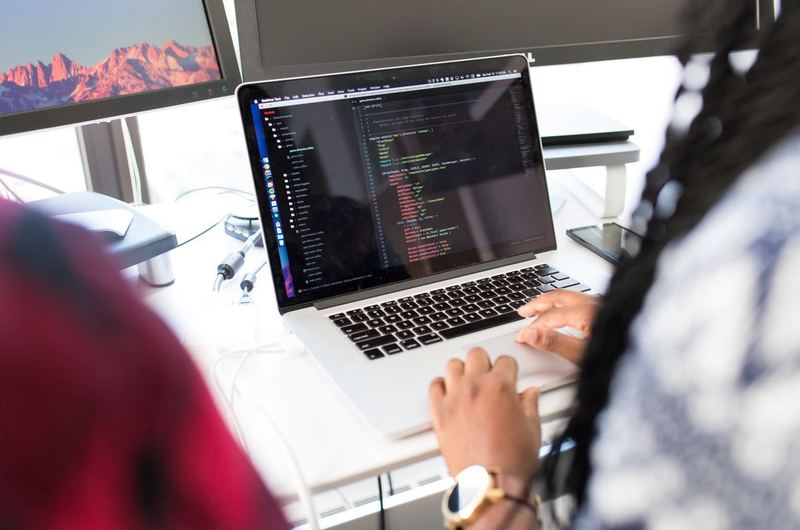 A developer reviewing performance metrics on a laptop screen